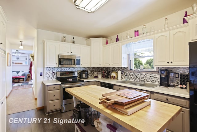 3405 S Miller Rd, Saginaw, MI 48609 - kitchen featuring stainless steel appliances, wood counters, decorative backsplash, and dark wood-style floors