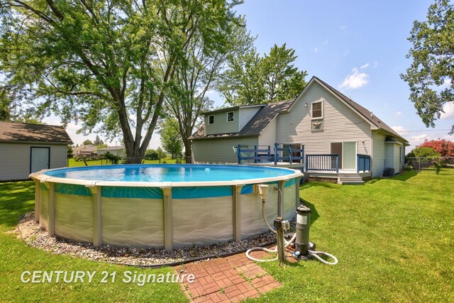 3405 S Miller Rd, Saginaw, MI 48609 - view of swimming pool with a deck and a yard