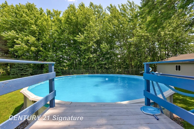 3405 S Miller Rd, Saginaw, MI 48609 - view of swimming pool featuring a wooden deck and view of scattered trees