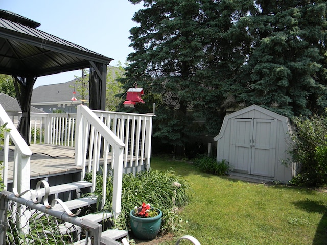 103 S Staffon St, Ludington, MI 49431 - view of grassy yard featuring a storage shed, a wooden deck, and a gazebo