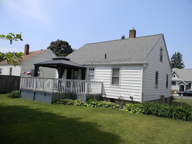 103 S Staffon St, Ludington, MI 49431 - rear view of property featuring a gazebo, roof with shingles, and a chimney