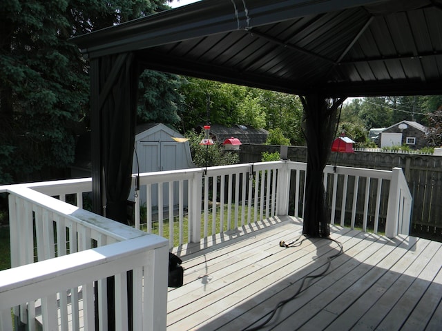 103 S Staffon St, Ludington, MI 49431 - deck featuring a storage shed, a fenced backyard, and a gazebo