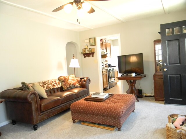 103 S Staffon St, Ludington, MI 49431 - living area featuring light carpet, ceiling fan, and arched walkways