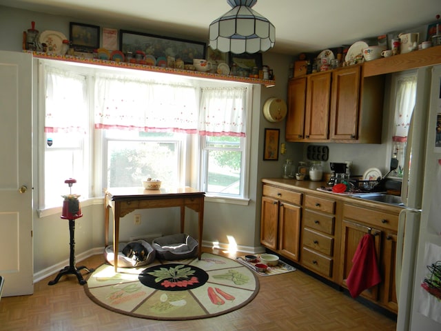 103 S Staffon St, Ludington, MI 49431 - kitchen featuring brown cabinets and freestanding refrigerator