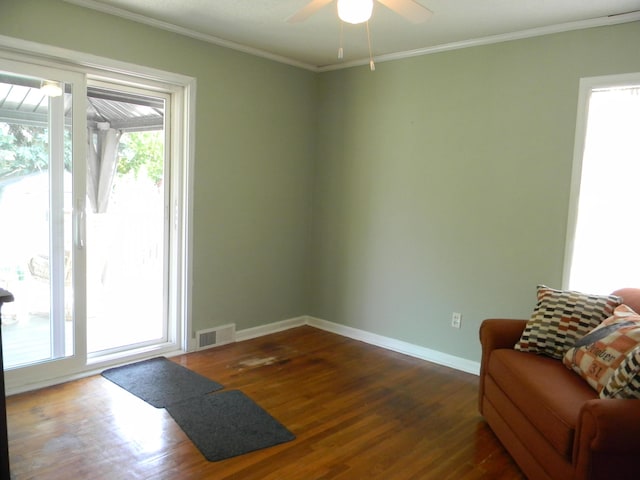 103 S Staffon St, Ludington, MI 49431 - sitting room with a ceiling fan, dark wood-style flooring, and ornamental molding