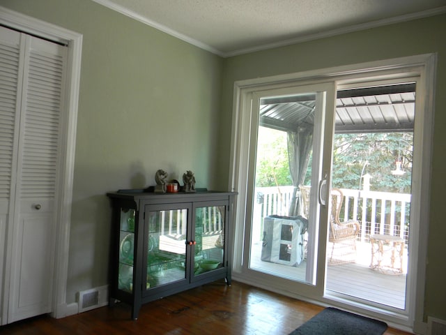 103 S Staffon St, Ludington, MI 49431 - doorway featuring ornamental molding and wood finished floors