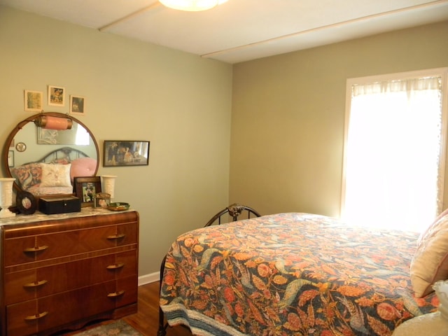 103 S Staffon St, Ludington, MI 49431 - bedroom with dark wood-style flooring and baseboards