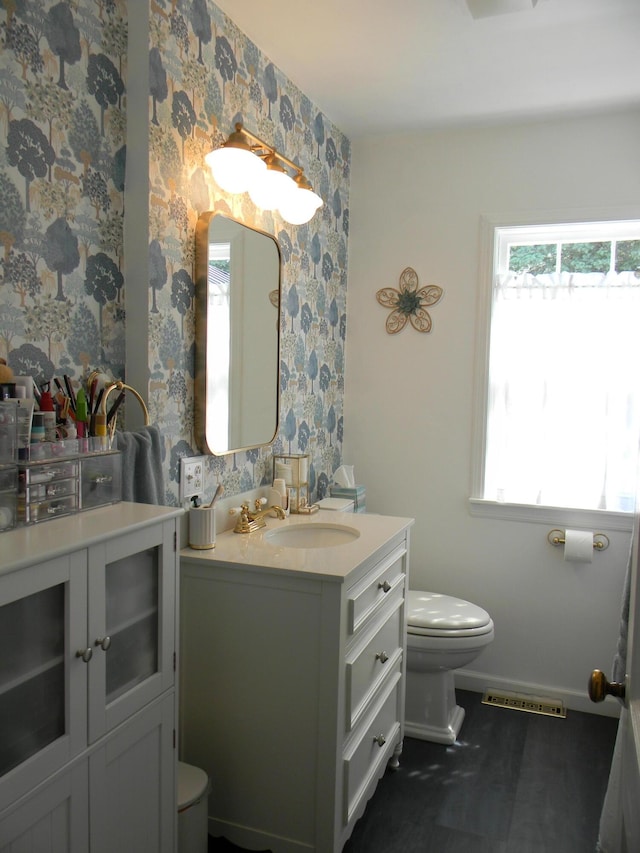103 S Staffon St, Ludington, MI 49431 - bathroom featuring wallpapered walls and vanity