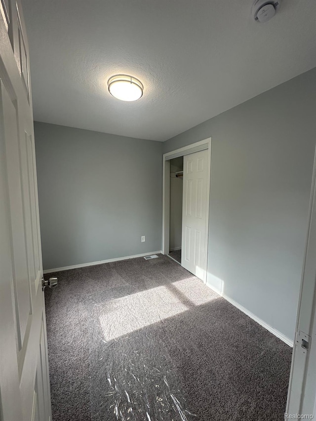 17788 Quarry St, Riverview, MI 48193 - unfurnished bedroom featuring carpet, a textured ceiling, and a closet