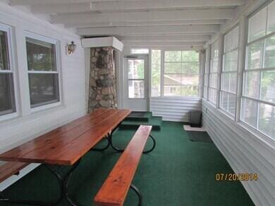777 W Lincoln Ave, White Cloud, MI 49349 - sunroom featuring beam ceiling and carpet flooring