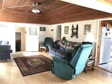 777 W Lincoln Ave, White Cloud, MI 49349 - living room with wooden ceiling, lofted ceiling, wood finished floors, and ceiling fan