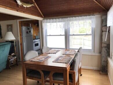 777 W Lincoln Ave, White Cloud, MI 49349 - dining area with light wood-style floors and wood ceiling