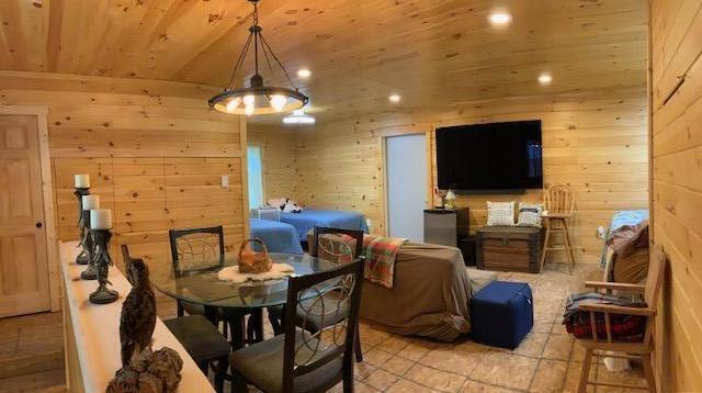 777 W Lincoln Ave, White Cloud, MI 49349 - dining room with wooden ceiling, wood walls, recessed lighting, and light tile patterned floors
