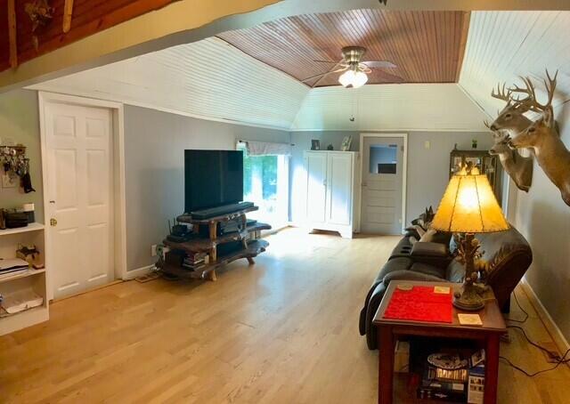 777 W Lincoln Ave, White Cloud, MI 49349 - living room with vaulted ceiling, wooden ceiling, ceiling fan, and wood finished floors