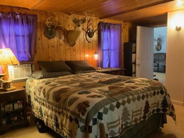 777 W Lincoln Ave, White Cloud, MI 49349 - carpeted bedroom with wooden ceiling, wooden walls, and cooling unit