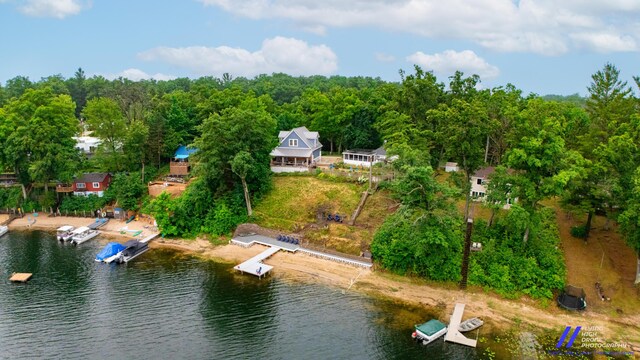 777 W Lincoln Ave, White Cloud, MI 49349 - aerial view of property and surrounding area with a large body of water and a forest