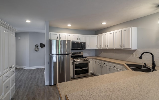 10068 S Crossroads Cir SE, Caledonia, MI 49316 - kitchen featuring stainless steel appliances, dark wood finished floors, backsplash, light countertops, and white cabinetry