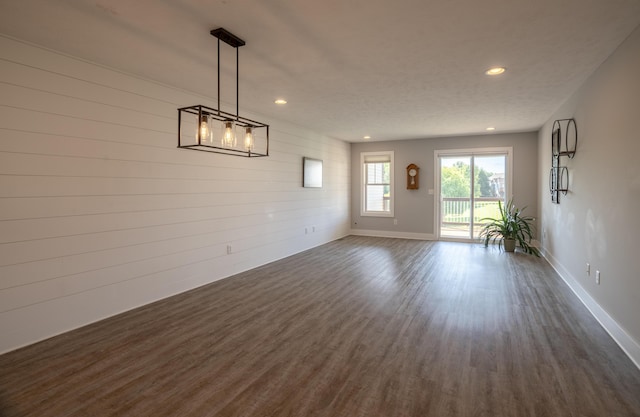 10068 S Crossroads Cir SE, Caledonia, MI 49316 - spare room featuring recessed lighting, dark wood-style floors, and wooden walls