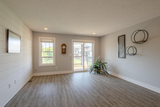 10068 S Crossroads Cir SE, Caledonia, MI 49316 - spare room featuring wood finished floors, recessed lighting, and wood walls