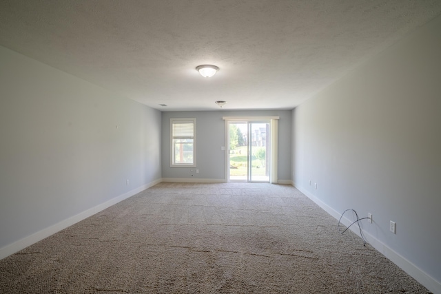 10068 S Crossroads Cir SE, Caledonia, MI 49316 - empty room featuring light colored carpet and a textured ceiling