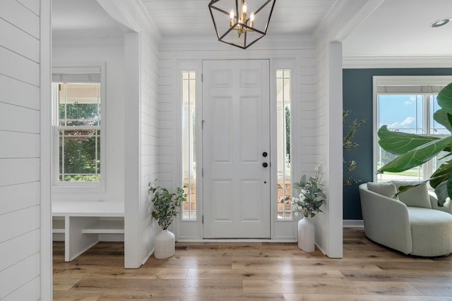 8375 Grapevine Circle, Cir, MI 49071 - foyer featuring ornamental molding, plenty of natural light, wood finished floors, and a chandelier