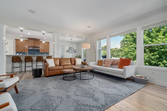 8375 Grapevine Circle, Cir, MI 49071 - living room with decorative columns, healthy amount of natural light, light wood-type flooring, crown molding, and recessed lighting