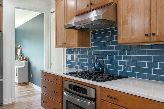 8375 Grapevine Circle, Cir, MI 49071 - kitchen featuring under cabinet range hood, stainless steel oven, crown molding, light wood-style floors, and tasteful backsplash