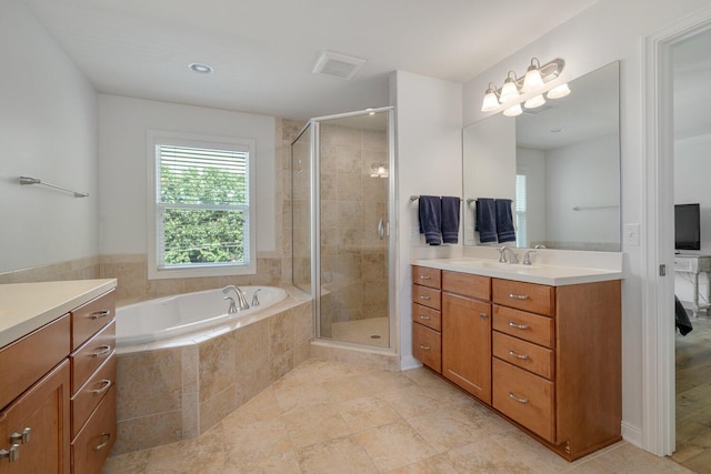 8375 Grapevine Circle, Cir, MI 49071 - full bathroom with vanity, a shower stall, a garden tub, and tile patterned floors