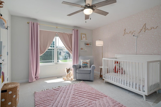 8375 Grapevine Circle, Cir, MI 49071 - carpeted bedroom featuring a crib, ceiling fan, and wallpapered walls