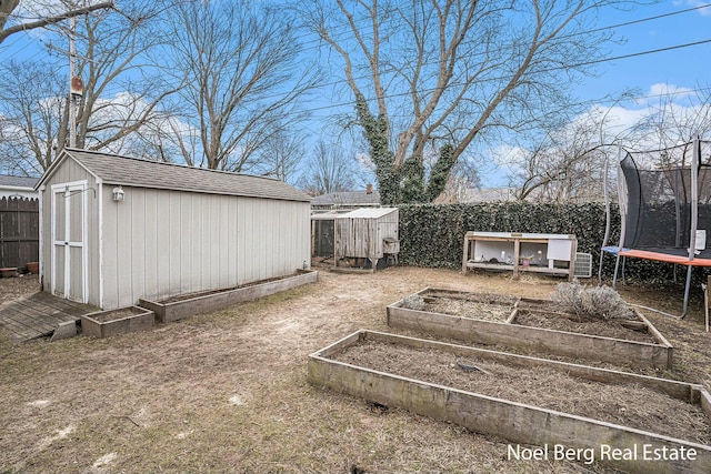 1314 Grant St, Grand Haven, MI 49417 - fenced backyard with a trampoline, a storage unit, and a garden