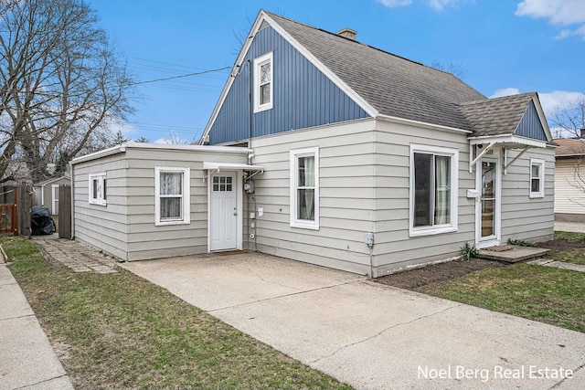 1314 Grant St, Grand Haven, MI 49417 - view of front of house featuring roof with shingles and a chimney