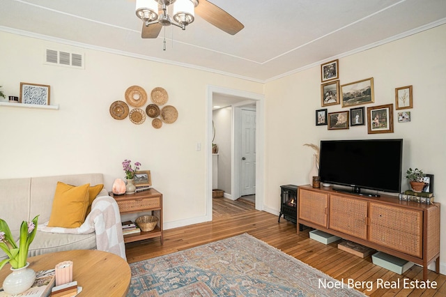 1314 Grant St, Grand Haven, MI 49417 - living room featuring a ceiling fan, wood finished floors, and ornamental molding