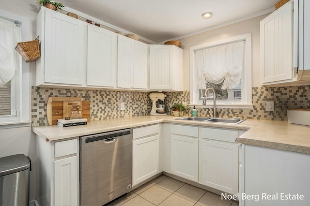 1314 Grant St, Grand Haven, MI 49417 - kitchen featuring dishwasher, decorative backsplash, light tile patterned floors, white cabinets, and light countertops