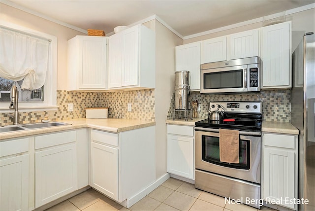 1314 Grant St, Grand Haven, MI 49417 - kitchen with appliances with stainless steel finishes, light tile patterned floors, decorative backsplash, crown molding, and light countertops