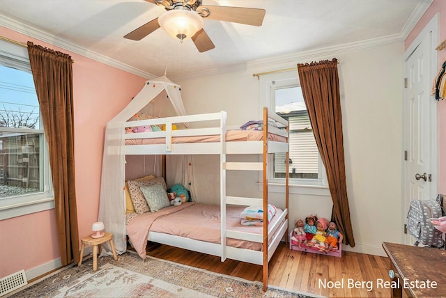 1314 Grant St, Grand Haven, MI 49417 - bedroom with wood finished floors, ornamental molding, and ceiling fan