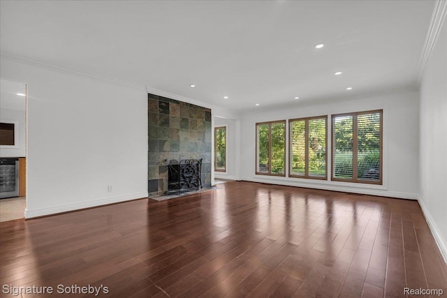 1656 Keller Ln, Bloomfield Hills, MI 48302 - unfurnished living room featuring ornamental molding, a tile fireplace, wood finished floors, recessed lighting, and beverage cooler
