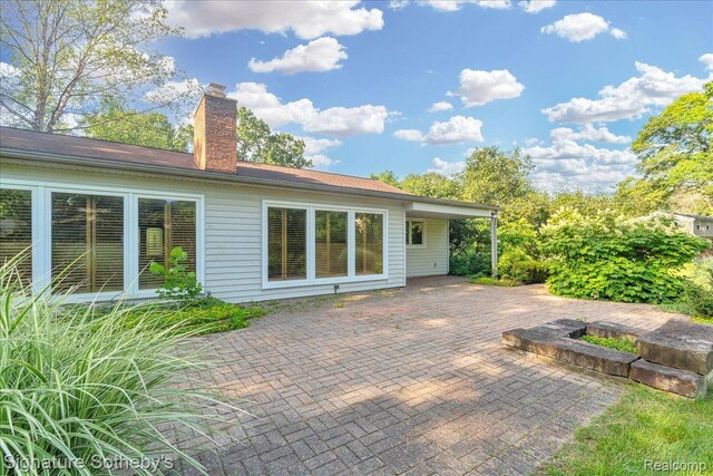 1656 Keller Ln, Bloomfield Hills, MI 48302 - rear view of property with a patio and a chimney