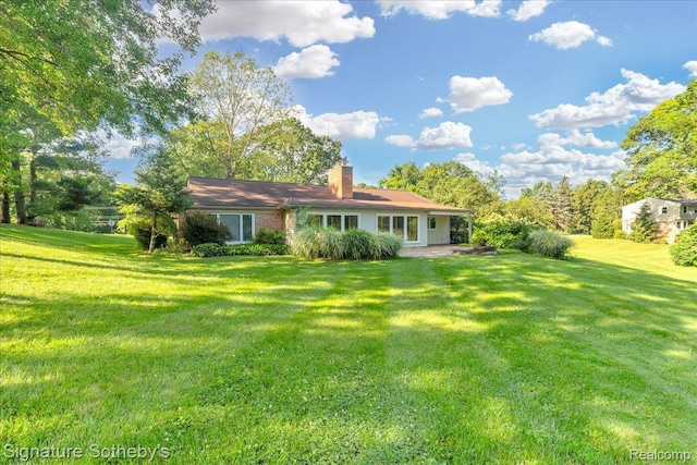 1656 Keller Ln, Bloomfield Hills, MI 48302 - back of property with a chimney and a lawn