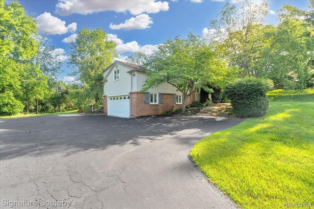 1656 Keller Ln, Bloomfield Hills, MI 48302 - view of side of property featuring brick siding, an attached garage, and asphalt driveway