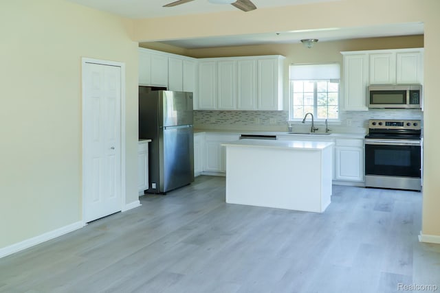 1803 Pinecroft Dr, Canton, MI 48188 - kitchen with appliances with stainless steel finishes, tasteful backsplash, light wood-style flooring, and white cabinetry