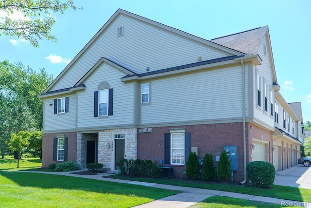 1803 Pinecroft Dr, Canton, MI 48188 - view of property with an attached garage, a front yard, and brick siding