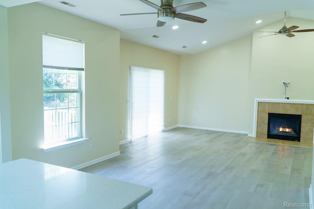 1803 Pinecroft Dr, Canton, MI 48188 - unfurnished living room featuring ceiling fan, a tiled fireplace, recessed lighting, light wood finished floors, and lofted ceiling