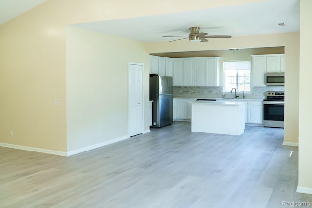 1803 Pinecroft Dr, Canton, MI 48188 - kitchen with appliances with stainless steel finishes, tasteful backsplash, white cabinetry, a ceiling fan, and light countertops