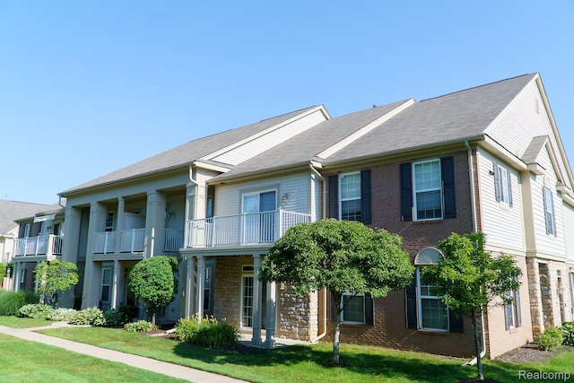 1803 Pinecroft Dr, Canton, MI 48188 - view of front of home with a front lawn, brick siding, and a balcony