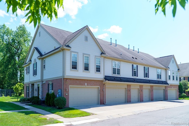 1803 Pinecroft Dr, Canton, MI 48188 - view of front of property with an attached garage, driveway, brick siding, and a front lawn