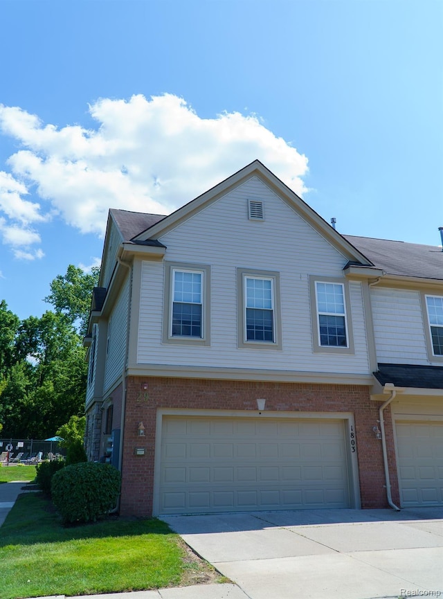 1803 Pinecroft Dr, Canton, MI 48188 - view of property with brick siding, an attached garage, and concrete driveway