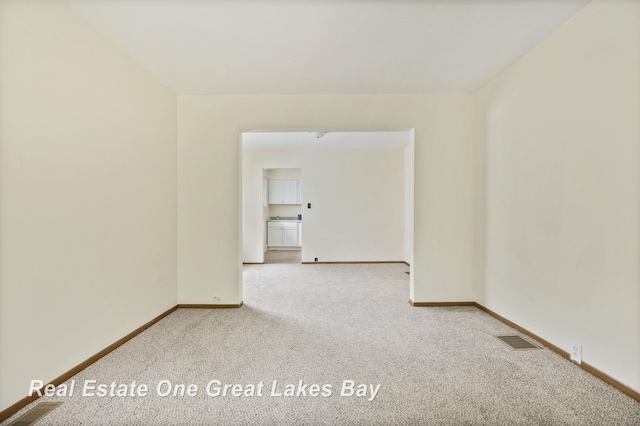 2249 N Clinton St, Saginaw, MI 48602 - unfurnished room featuring carpet floors and baseboards