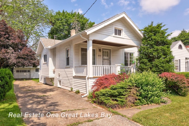 2249 N Clinton St, Saginaw, MI 48602 - bungalow-style house featuring a porch and a chimney