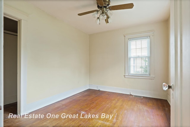 2249 N Clinton St, Saginaw, MI 48602 - unfurnished bedroom with baseboards and wood finished floors