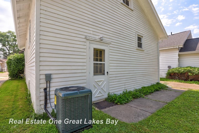 2249 N Clinton St, Saginaw, MI 48602 - view of home's exterior featuring a central AC unit and a lawn